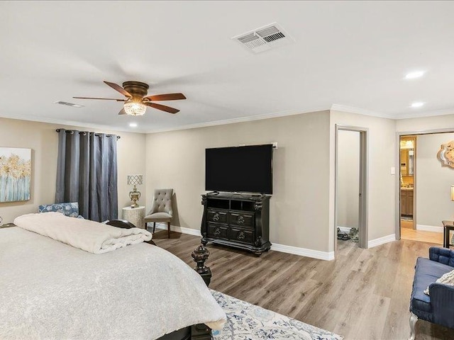 bedroom with connected bathroom, ceiling fan, light hardwood / wood-style floors, and ornamental molding