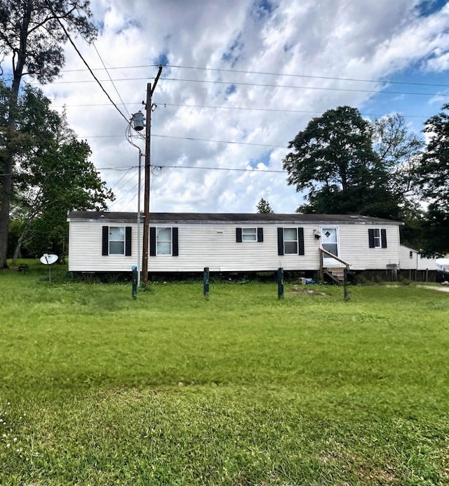 back of house with a lawn