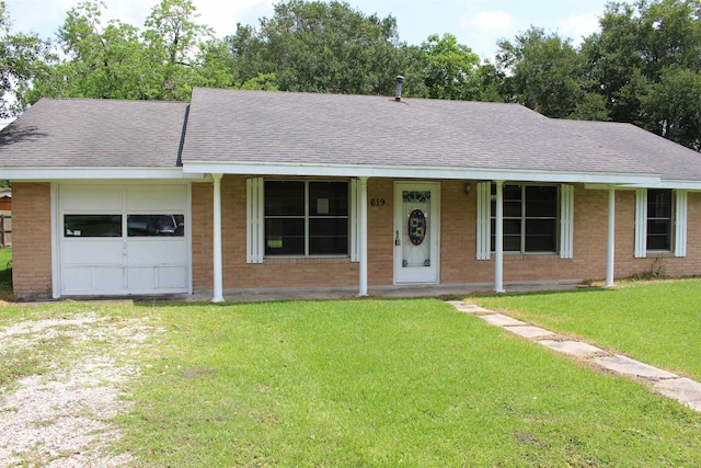 619 Carolyn St, Winnie, TX 77665 - single story home featuring brick siding, a shingled roof, and a front yard