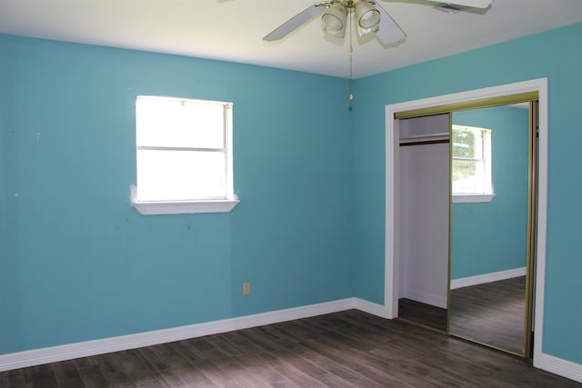 619 Carolyn St, Winnie, TX 77665 - unfurnished bedroom with a closet, dark wood-style floors, and ceiling fan