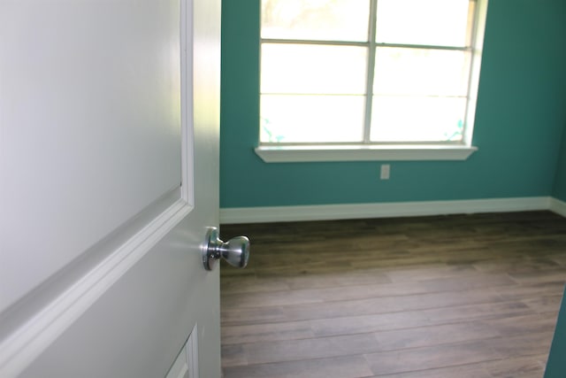 619 Carolyn St, Winnie, TX 77665 - unfurnished room with wood finished floors and baseboards