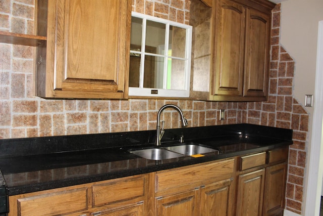 619 Carolyn St, Winnie, TX 77665 - kitchen featuring backsplash and brown cabinetry