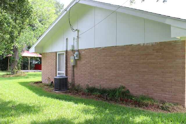 619 Carolyn St, Winnie, TX 77665 - view of home's exterior with brick siding and a yard