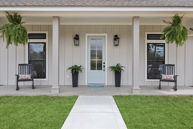 property entrance featuring board and batten siding, a porch, and roof with shingles