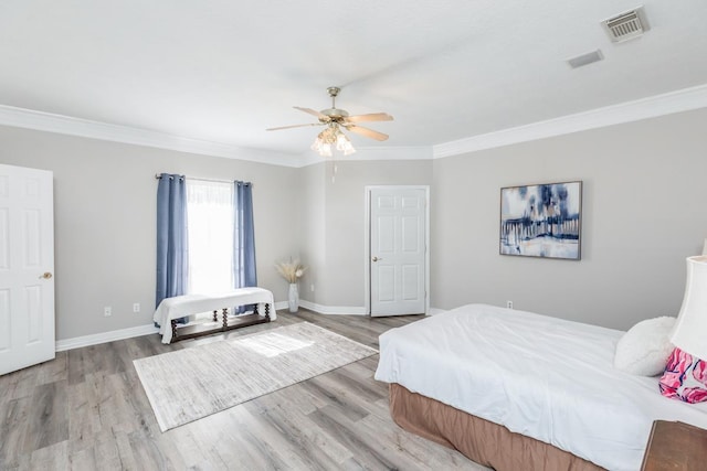 bedroom with light wood-type flooring, ceiling fan, and ornamental molding