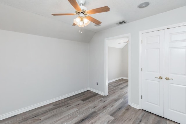 interior space featuring ceiling fan, light hardwood / wood-style floors, and vaulted ceiling