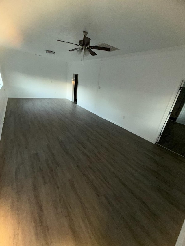 empty room featuring ceiling fan and dark hardwood / wood-style floors