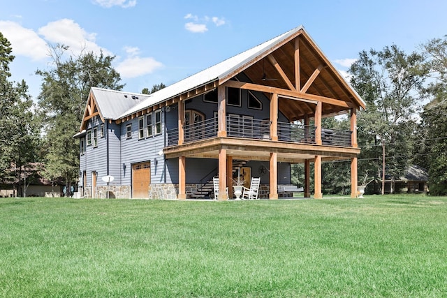 rear view of house with a yard and a deck