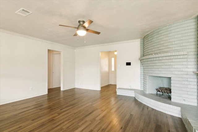 unfurnished living room with dark hardwood / wood-style flooring, ceiling fan, a fireplace, and ornamental molding