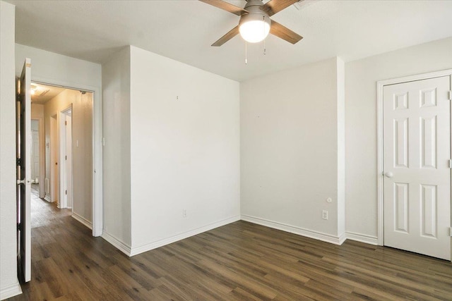 spare room featuring ceiling fan and dark hardwood / wood-style flooring