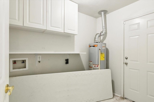 clothes washing area featuring cabinets, washer hookup, a textured ceiling, and water heater