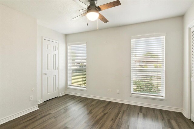 unfurnished room featuring dark hardwood / wood-style floors and ceiling fan