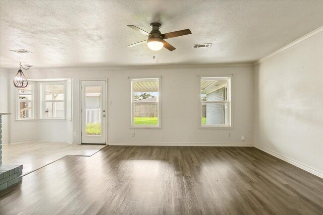 spare room featuring crown molding, ceiling fan with notable chandelier, dark hardwood / wood-style floors, and a textured ceiling