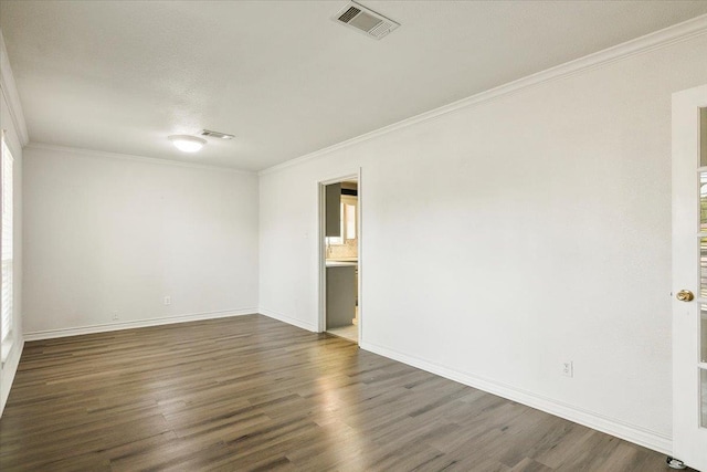 unfurnished room featuring dark wood-type flooring and ornamental molding