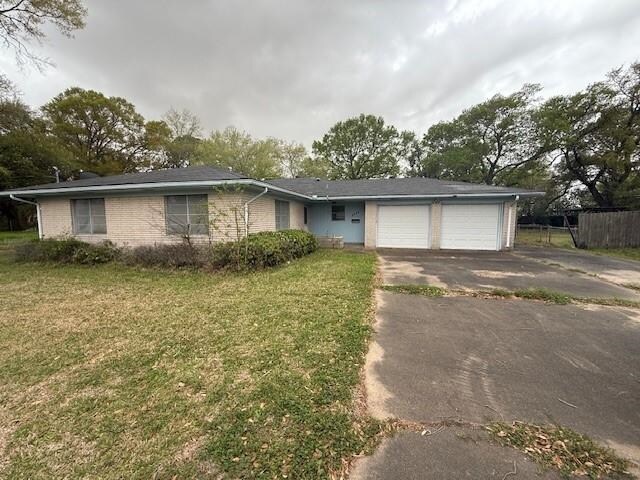 3911 Franklin Ave, Groves, TX 77619 - ranch-style home with driveway, brick siding, a garage, and a front lawn
