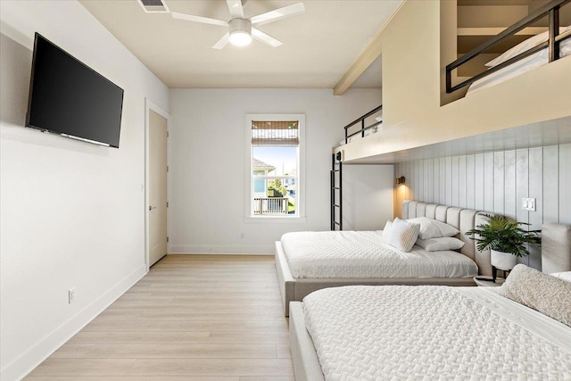 bedroom featuring beam ceiling, light wood-type flooring, and ceiling fan