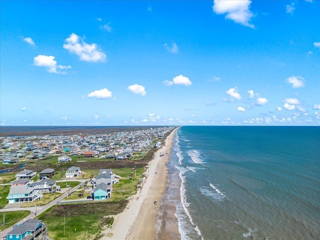 bird's eye view featuring a view of the beach and a water view