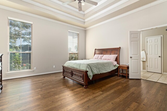 bedroom featuring multiple windows, ceiling fan, and ornamental molding