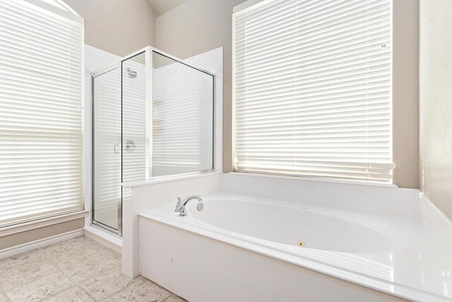 bathroom featuring independent shower and bath