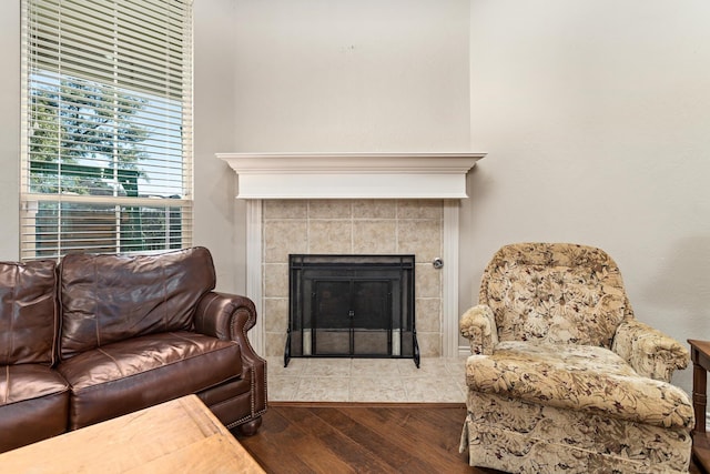 living room featuring hardwood / wood-style flooring and a tile fireplace