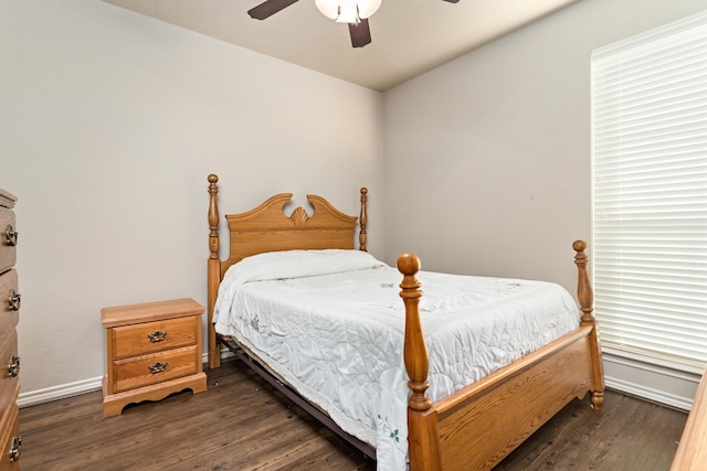 bedroom with dark hardwood / wood-style flooring and ceiling fan