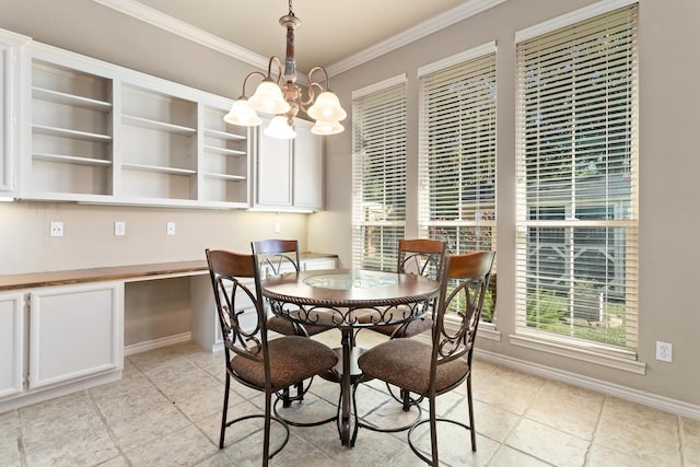 dining space with ornamental molding and a notable chandelier