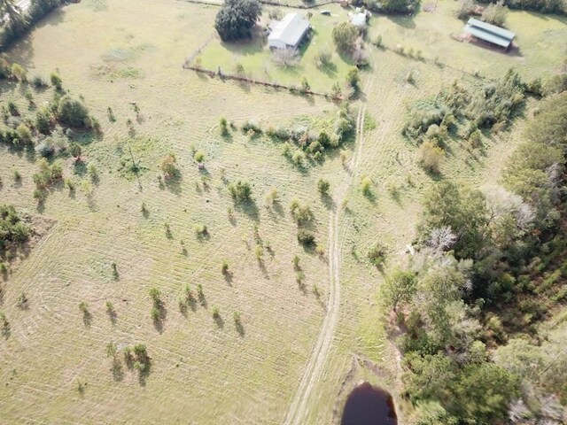 birds eye view of property with a rural view