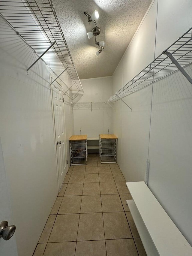 spacious closet featuring tile patterned flooring