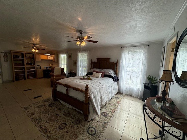 tiled bedroom featuring ceiling fan, ornamental molding, a textured ceiling, and multiple windows