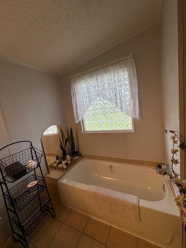 bathroom with tile patterned flooring, a textured ceiling, ornamental molding, and a washtub