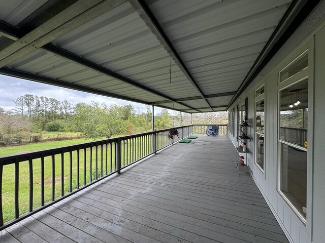 wooden deck with a lawn