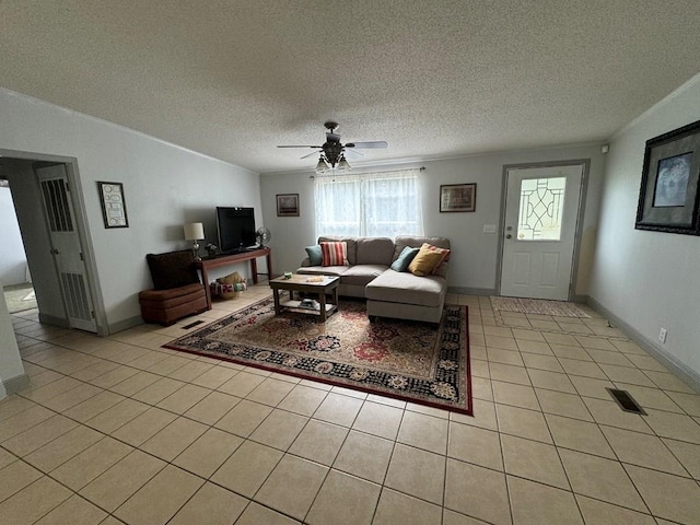 tiled living room with ceiling fan and a textured ceiling