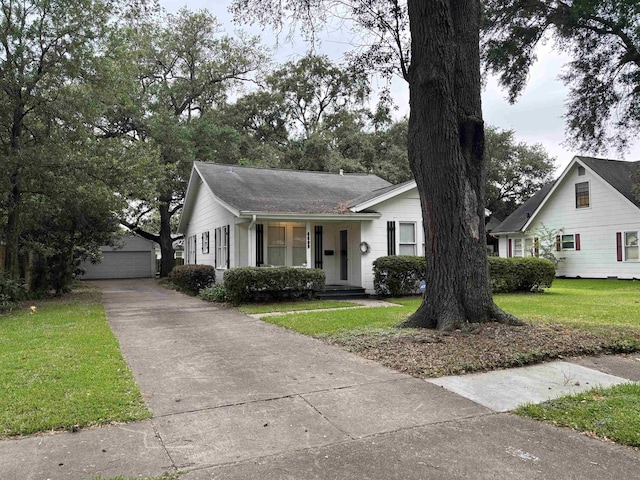 4609 Alamosa St, Port Arthur, TX 77642 - view of front of house featuring an outbuilding, a front yard, and a shingled roof
