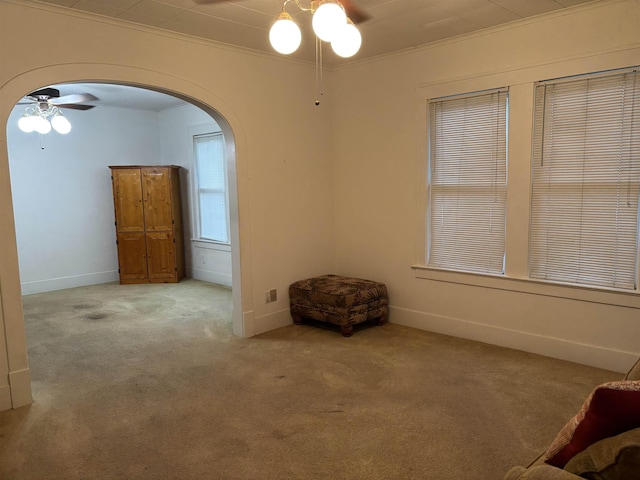 4609 Alamosa St, Port Arthur, TX 77642 - carpeted spare room featuring arched walkways, ceiling fan, crown molding, and baseboards
