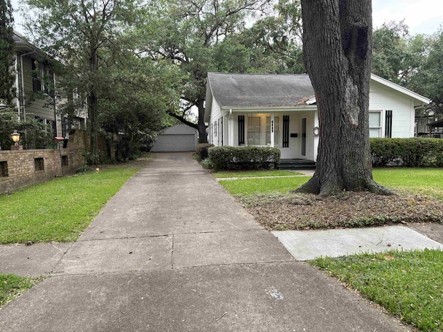 4609 Alamosa St, Port Arthur, TX 77642 - view of front of house featuring a front yard, an outdoor structure, a garage, and covered porch