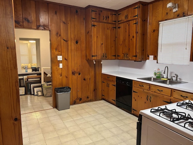 4609 Alamosa St, Port Arthur, TX 77642 - kitchen featuring dishwasher, range with gas cooktop, brown cabinets, a sink, and light countertops