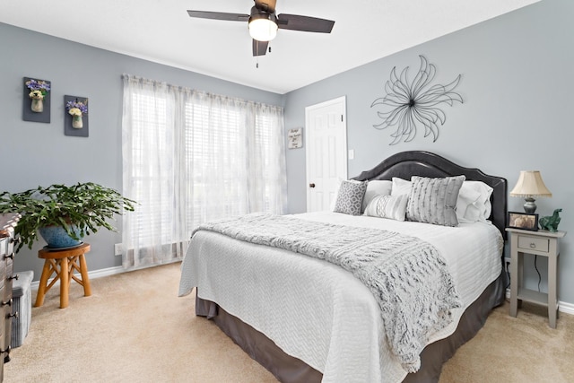 bedroom featuring light colored carpet and ceiling fan