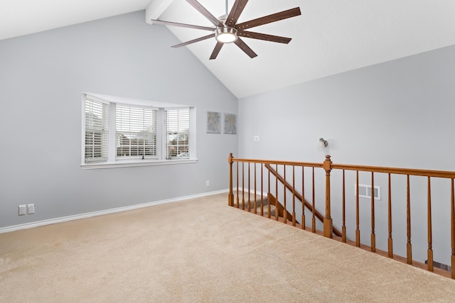 carpeted spare room featuring vaulted ceiling with beams and ceiling fan