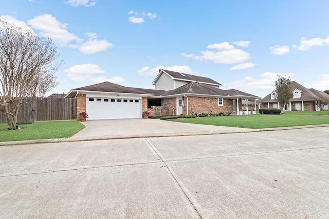 view of front of house with a front yard and a garage