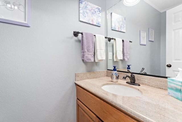 bathroom with crown molding and vanity