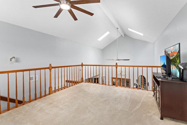 interior space with lofted ceiling with skylight and carpet