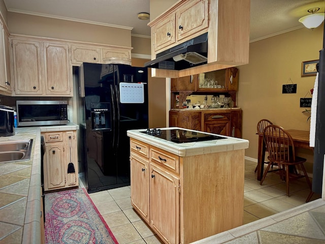 kitchen featuring black appliances, light brown cabinets, light tile patterned floors, tile countertops, and a center island