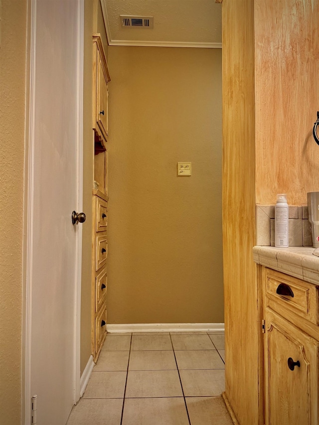 bathroom featuring tile patterned floors and ornamental molding