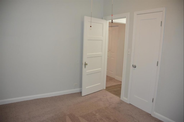 unfurnished bedroom featuring light colored carpet