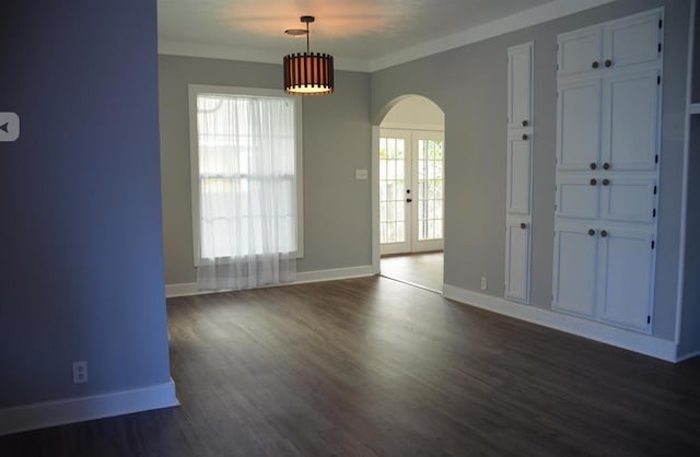 spare room with dark hardwood / wood-style flooring, crown molding, and french doors