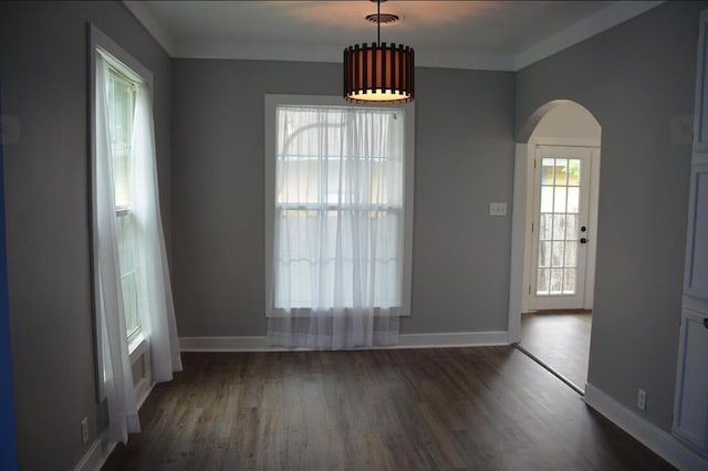 unfurnished dining area with dark hardwood / wood-style flooring and ornamental molding