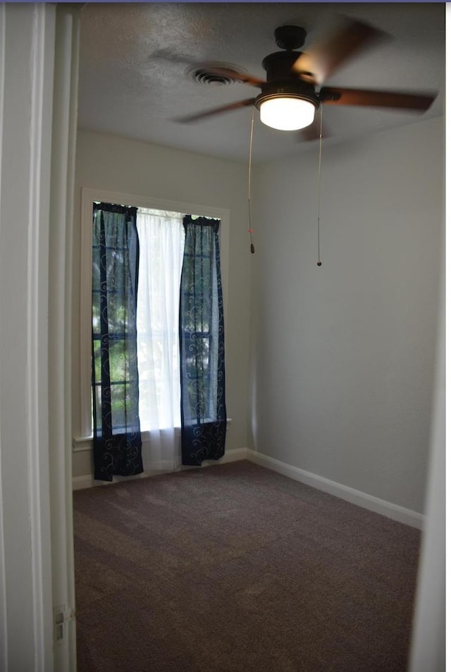 spare room with carpet flooring and ceiling fan