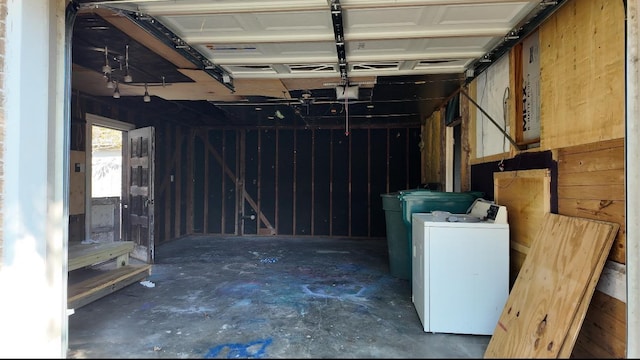 garage with washer / dryer and a garage door opener