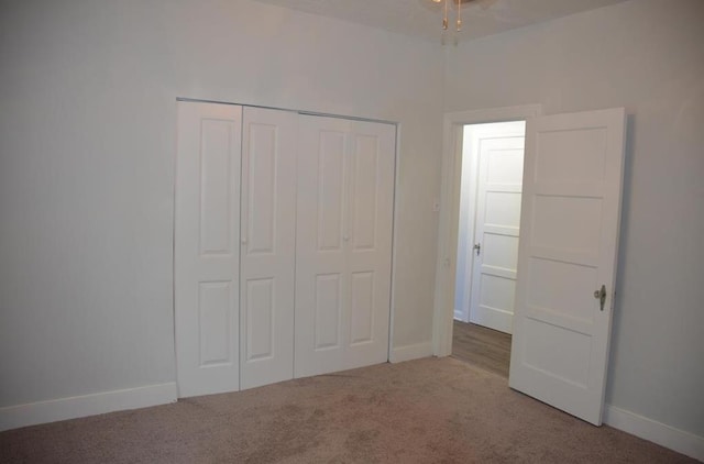 unfurnished bedroom with carpet flooring and a closet