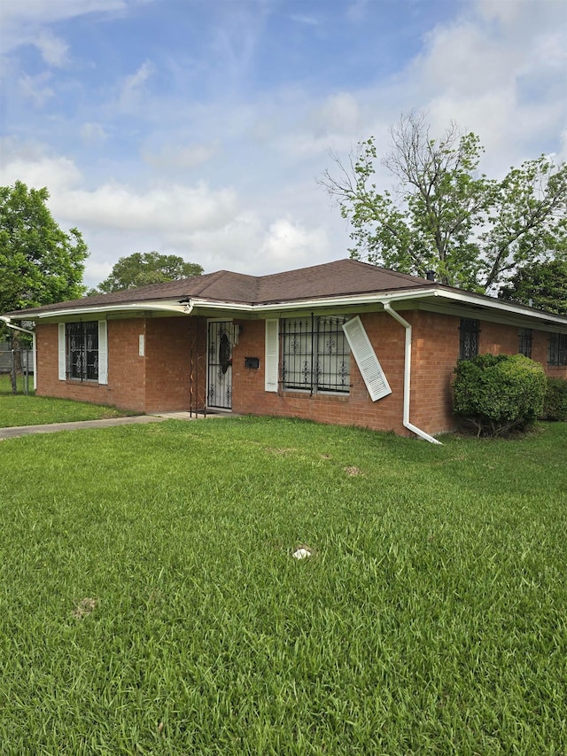 1610 Cartwright Ave, Beaumont, TX 77701 - ranch-style home with a front yard and brick siding